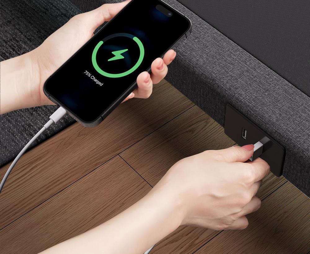A phone plugged into one of the two USB-A ports on the side of the frame